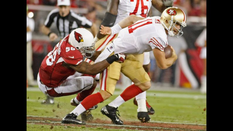 San Francisco 49ers quarterback Alex Smith is sacked by Daryl Washington of the Arizona Cardinals.