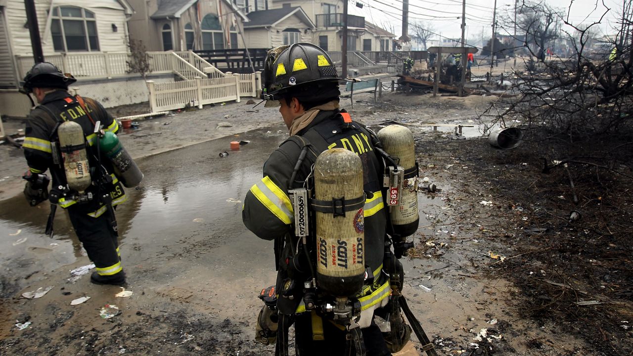 Firefighters work to contain the fire in Queens on Tuesday. Some 200 firefighters battled the six-alarm blaze.
