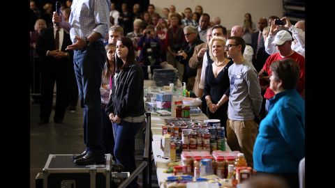 Supporters listen as Romney speaks at an event to collect food and supply donations for storm victims in Kettering, Ohio, Tuesday.