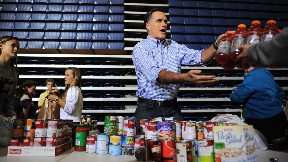 Mitt Romney helps gather donated goods for storm relief Tuesday in Kettering, Ohio.