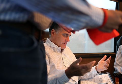 Romney talks with advisers on his campaign bus while en route to a rally at Avon Lake High School on Monday, October 29, in Avon Lake, Ohio.
