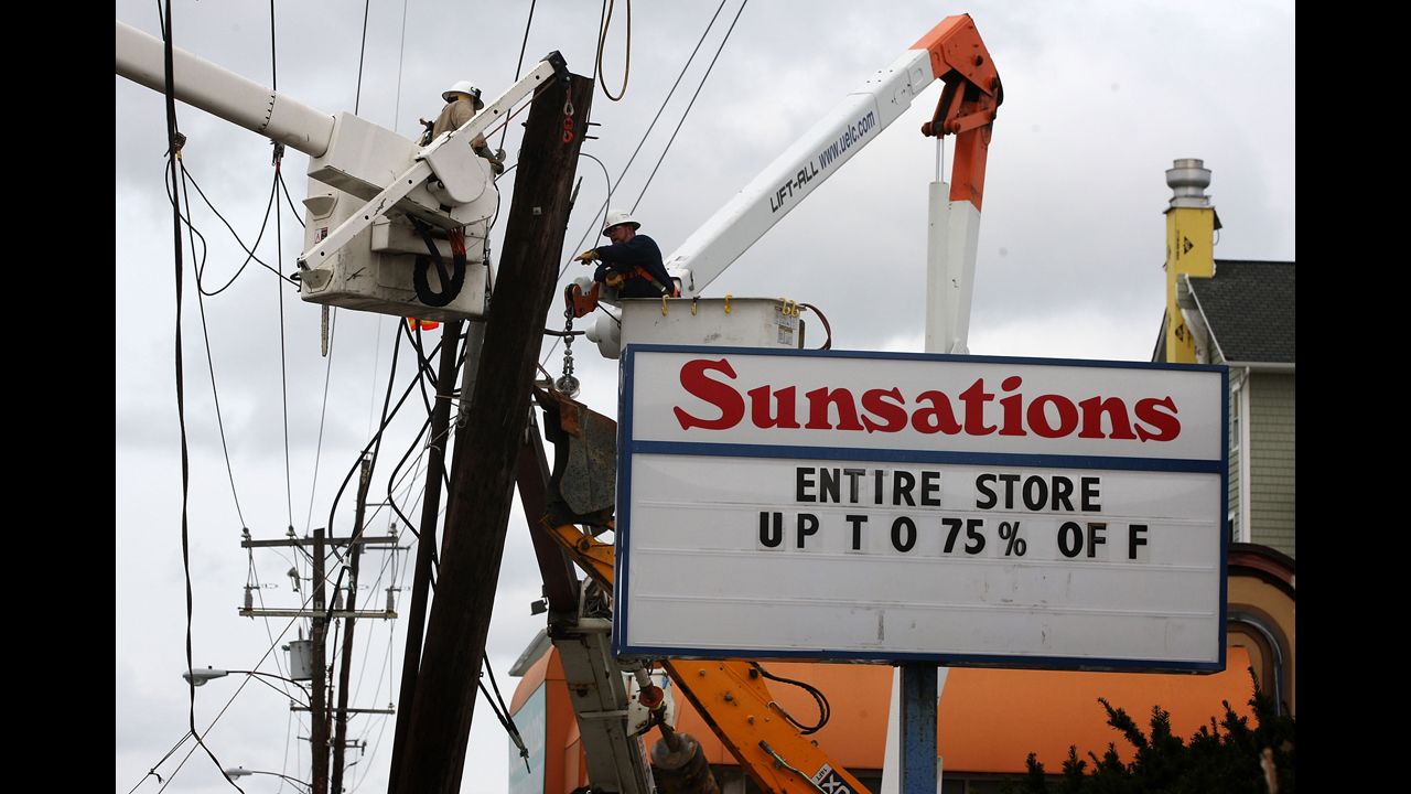 Utility workers from Delmarva Power replace a power pole that was damaged during Hurricane Sandy in Ocean City, Maryland, on Tuesday.
