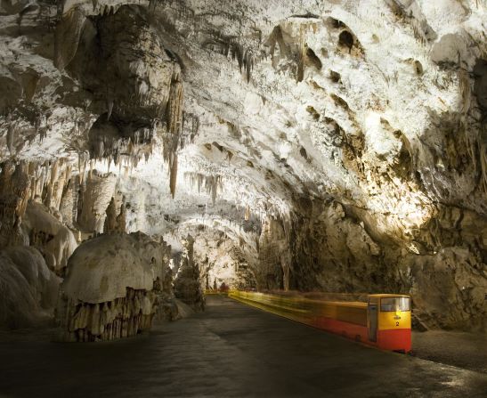 An electric train carries visitors on a two-mile route through Slovenia's Postojna Cave. 