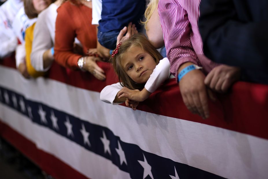  A young girl looks on during a campaign rally for Romney at Avon Lake High School on Monday.