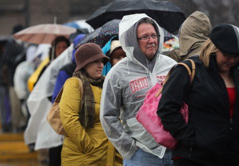 People line up in the rain for a campaign rally with Clinton and Biden on Monday in Youngstown, Ohio.