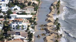 Work crews push sand from a roadway in Fort Lauderdale, Florida, due to storm surge related flooding on October 29.