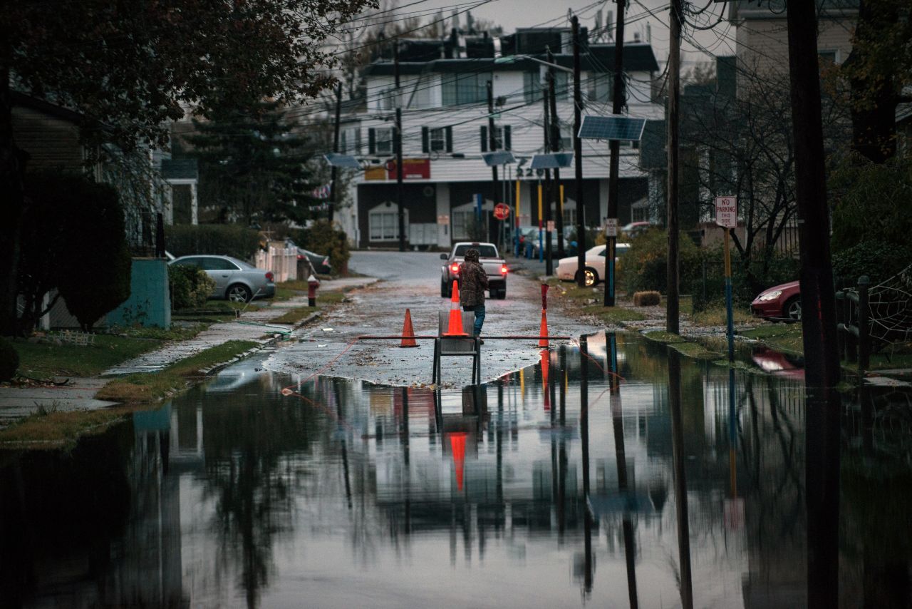 A man stands near a homemade road block on Tuesday in Little Ferry, New Jersey.  