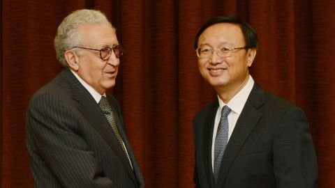 Lakhdar Brahimi, left, shakes hands with Yang Jiechi before their meeting in Beijing on Wednesday.