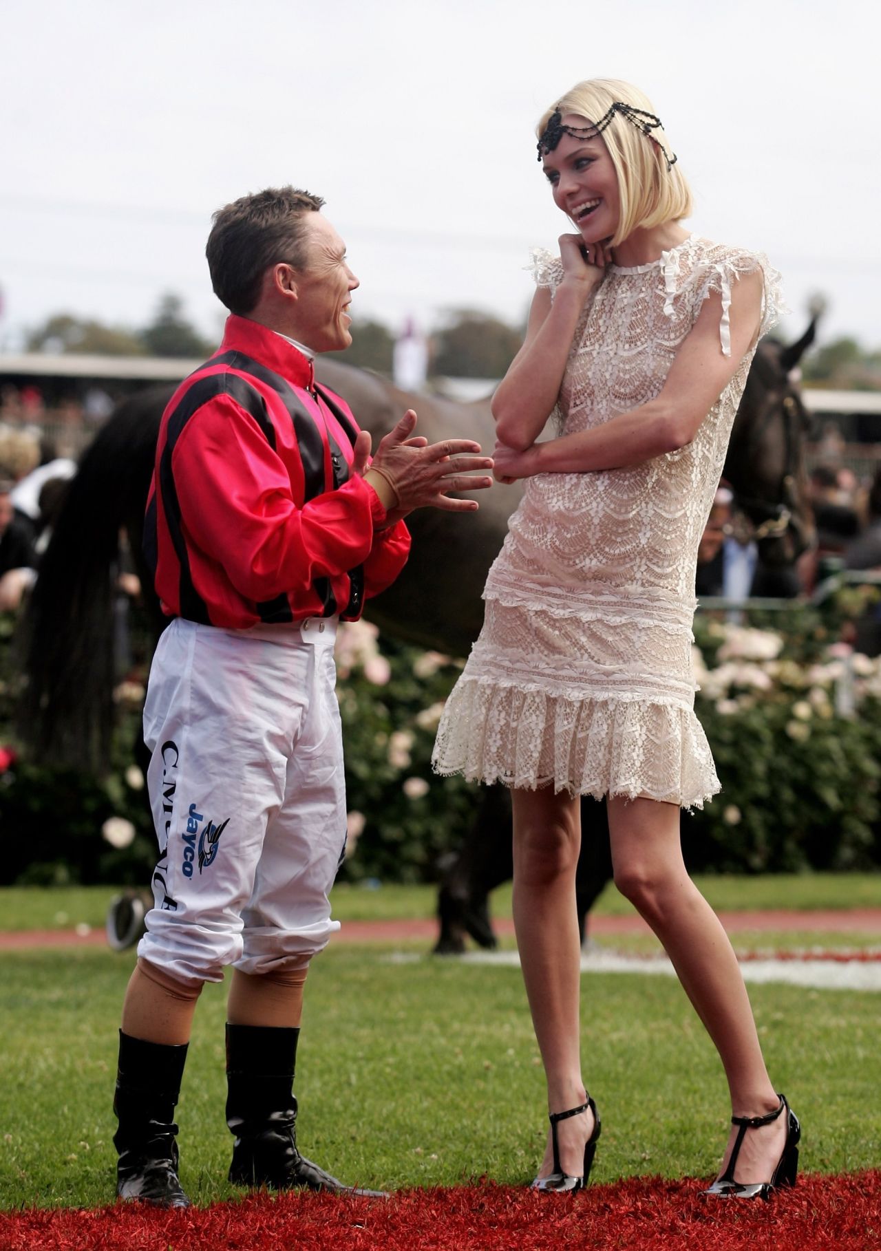 Actress Kate Bosworth chats to jockey Chris Munce at the 2006 carnival. The mild Australian climate means punters aren't obliged to wear jackets and gloves.