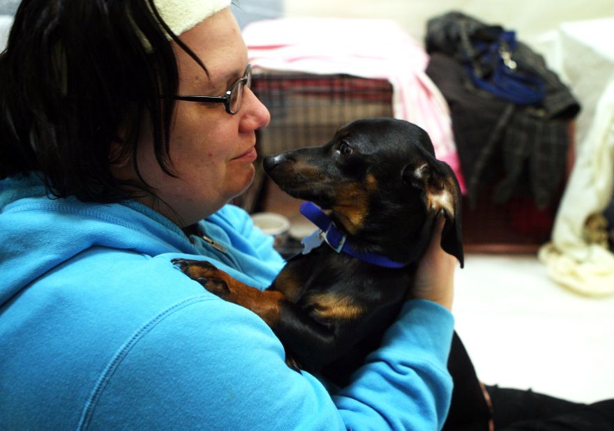 Long Neck, Delaware, resident Kim Levan and her dog Charlie take shelter at Cape Henlopen High School in Lewes, Delaware as Hurricane Sandy approaches. 