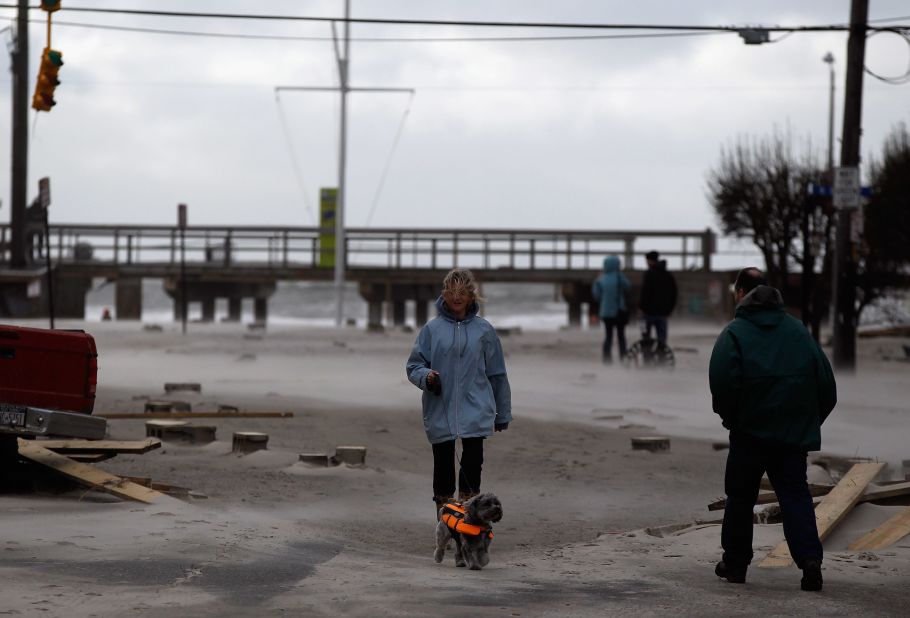 Residents of Long Beach, New York, get a look at their streets, covered by debris and beach sand, on Tuesday, October 30, the day after Hurricane Sandy hit.