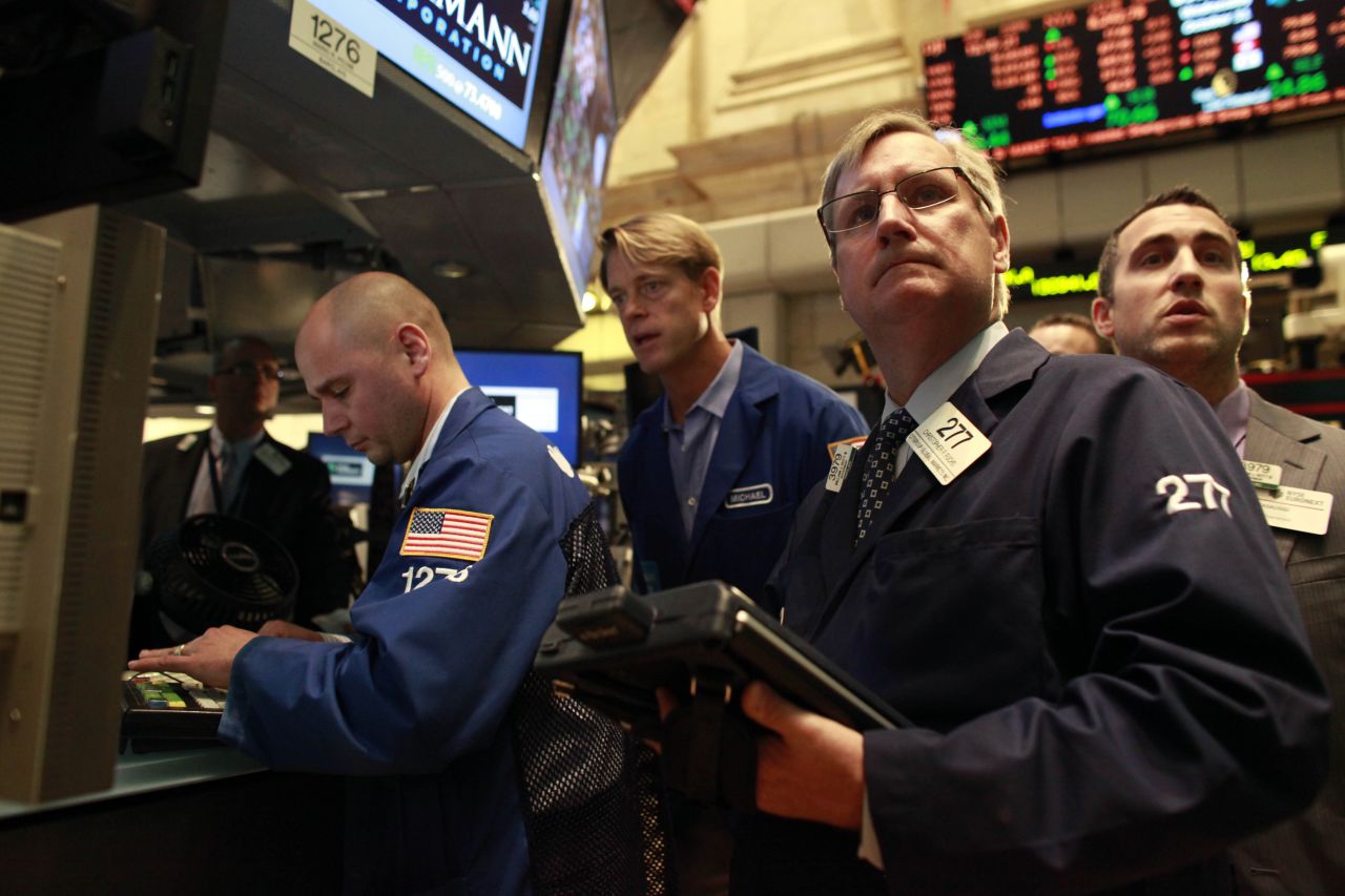 Traders work on the floor of the New York Stock Exchange on Wednesday after it had been closed for two days.