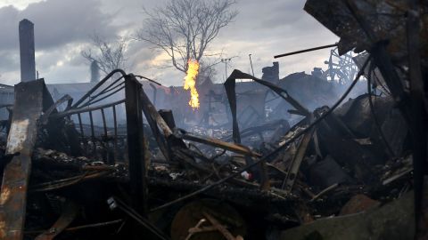 Firefighters continued to survey the damage in Rockaway on Wednesday. At least 80 homes were destroyed.