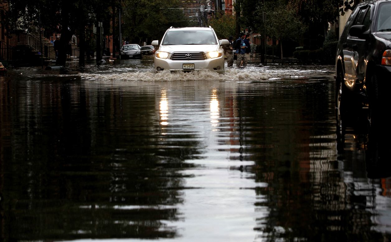 Motorists drive through standing water in Hoboken, New Jersey. Known as the Mile Square City, the low-lying neighborhoods suffered deep flooding resulting from the storm surge associated with Hurricane Sandy.