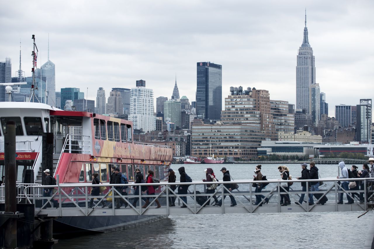 People board the ferry, one of the few functioning transportation systems, in Hoboken, New Jersey, on Wednesday, October 31.