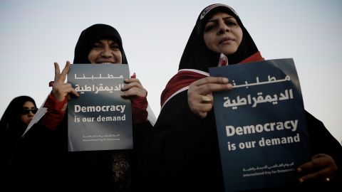 Bahraini Shiite Muslim women hold signs during an anti-government rally in the village of Shakhora on September 14.
