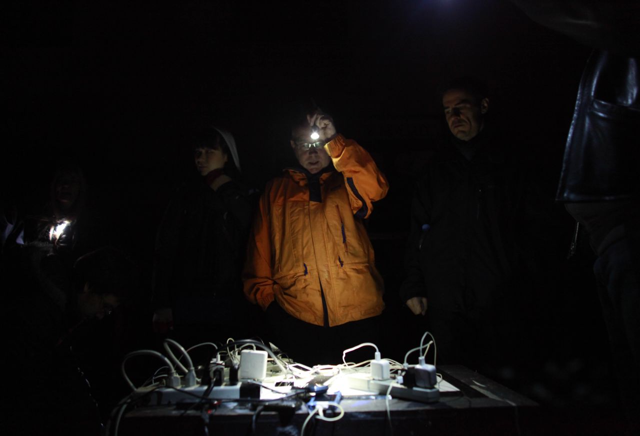 East Village residents charge their phones with power from a generator on Wednesday.