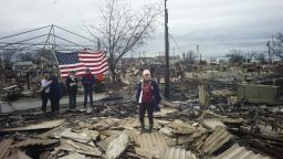 QUEENS, NY
OCTOBER 31, 2012
Local residents return to widespread damage and fire that destroyed many houses, caused by Hurricane Sandy in the Breezy Point section of the Rockaways in Queens. They raised an American flag on the ruins of their home.
Photograph by ALAN CHIN
