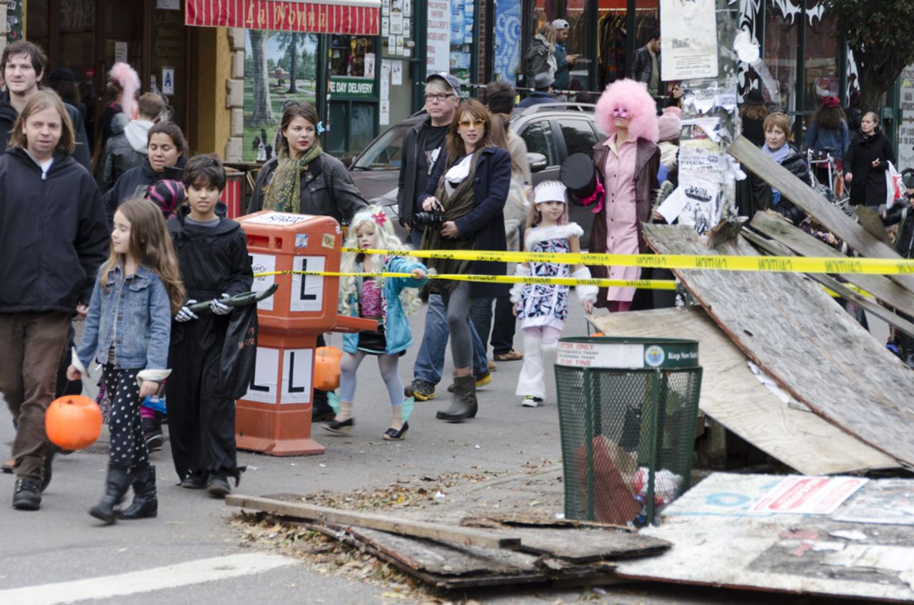 <a href="http://ireport.cnn.com/docs/DOC-869953">Luis C. Muniz</a> snapped this photo of trick-or-treaters in Brooklyn making their way amid damage brought on by Superstorm Sandy. 