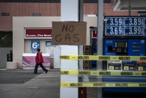 A woman leaves an Exxon gas station that was out of fuel on Thursday in North Bergen, New Jersey.