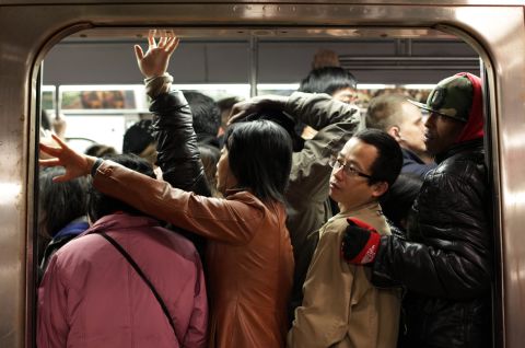 Commuters pack into a train on Thursday in New York City. Limited public transit has returned to the city, where 14 of 23 subway lines are running. 