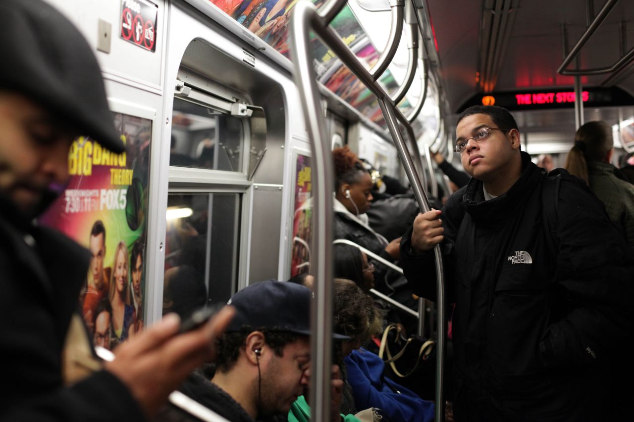 Commuters ride the subway. Public transit is operating in New York City, but travel times are long, up to five hours in some cases.