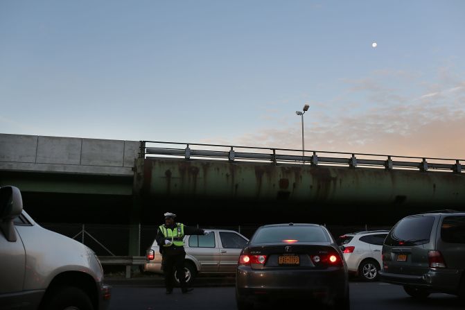 A police officer directs traffic entering the Brooklyn Queens Expressway into Manhattan. 