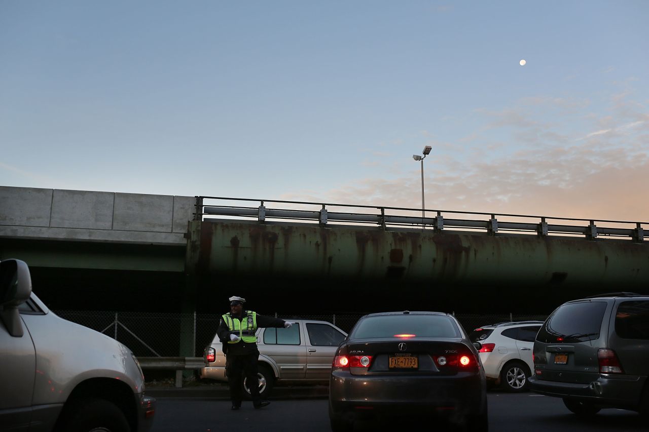 A police officer directs traffic entering the Brooklyn Queens Expressway into Manhattan.