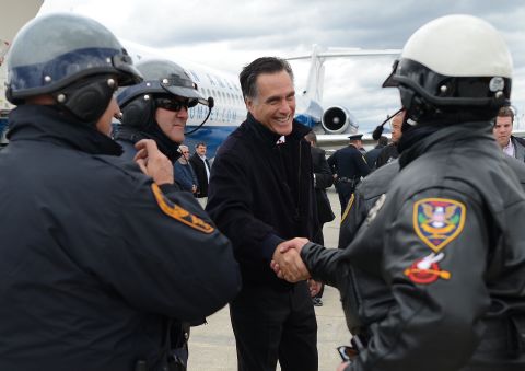 U.S. Republican Presidential candidate Mitt Romney greets policemen who were part of his motorcade as he prepares to board his campaign plane in Roanoke, Virginia on Thursday.