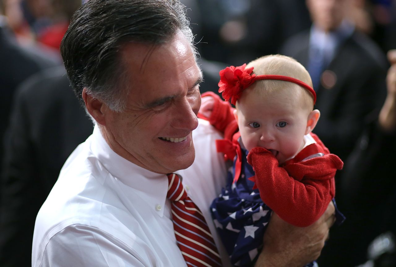 Mitt Romney holds a baby during a campaign event at Meadow Event Park on Thursday.
