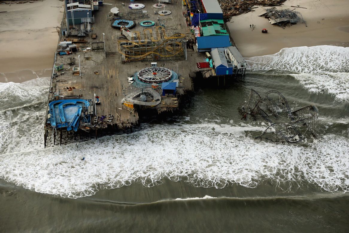 Waves break in front of an amusement park destroyed by Superstorm Sandy on Wednesday, October 31, in Seaside Heights, New Jersey. At least 56 people were killed in the storm. New Jersey suffered massive damage and power outages. 
