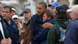 U.S. President Barack Obama comforts Superstorm Sandy victim Dana Vanzant as he visits a neighborhood in Brigantine, New Jersey, on Wednesday, October 31.