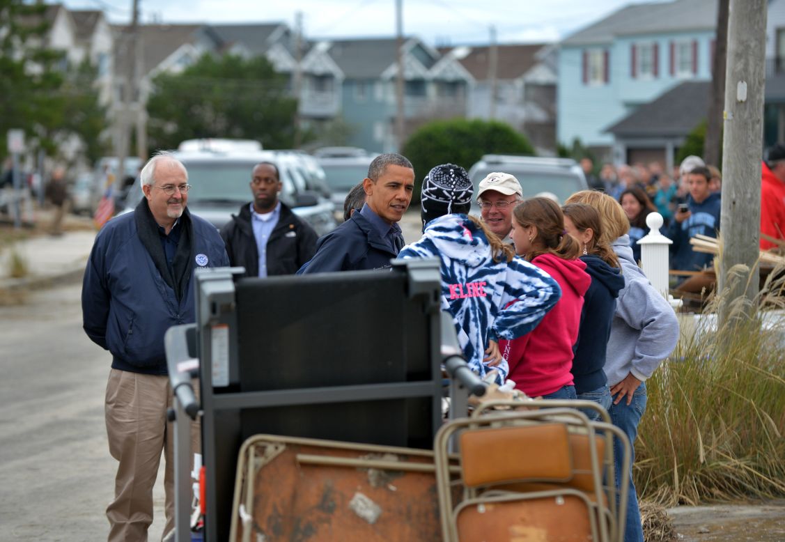 President Obama talks with Sandy victims at a neighborhood in Brigantine, New Jersey, as he travels around surveying the storm damage.