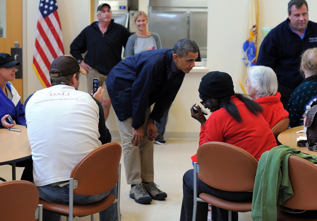 President Obama bends to talk to Sandy victims at a shelter in Brigantine.