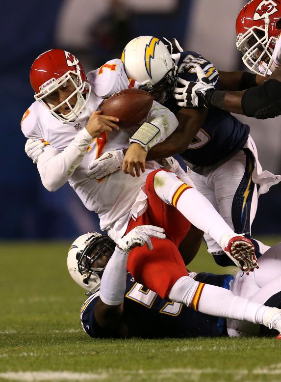Quarterback Matt Cassel of the Chiefs is tackled by linebacker Donald Butler and cornerback Marcus Gilchrist of the Chargers.