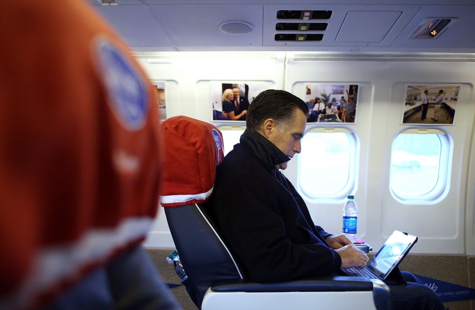 Republican presidential candidate Mitt Romney works aboard his campaign plane before takeoff Friday in Norfolk, Virginia.