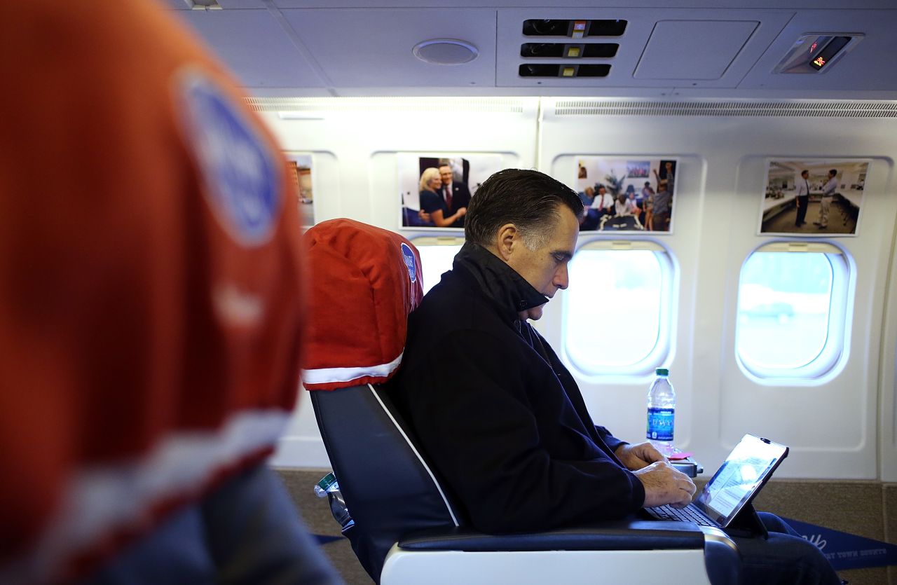 Republican presidential candidate Mitt Romney works aboard his campaign plane before takeoff Friday in Norfolk, Virginia.
