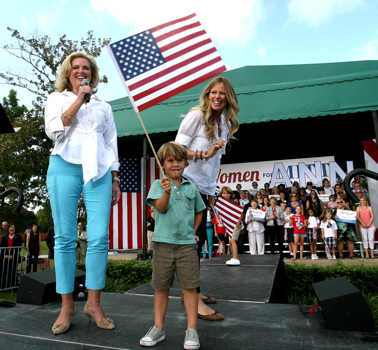 Ann Romney responds to cheering supporters with her grandson  Miles Romney and his mom, Mary Romney, in 2012.
