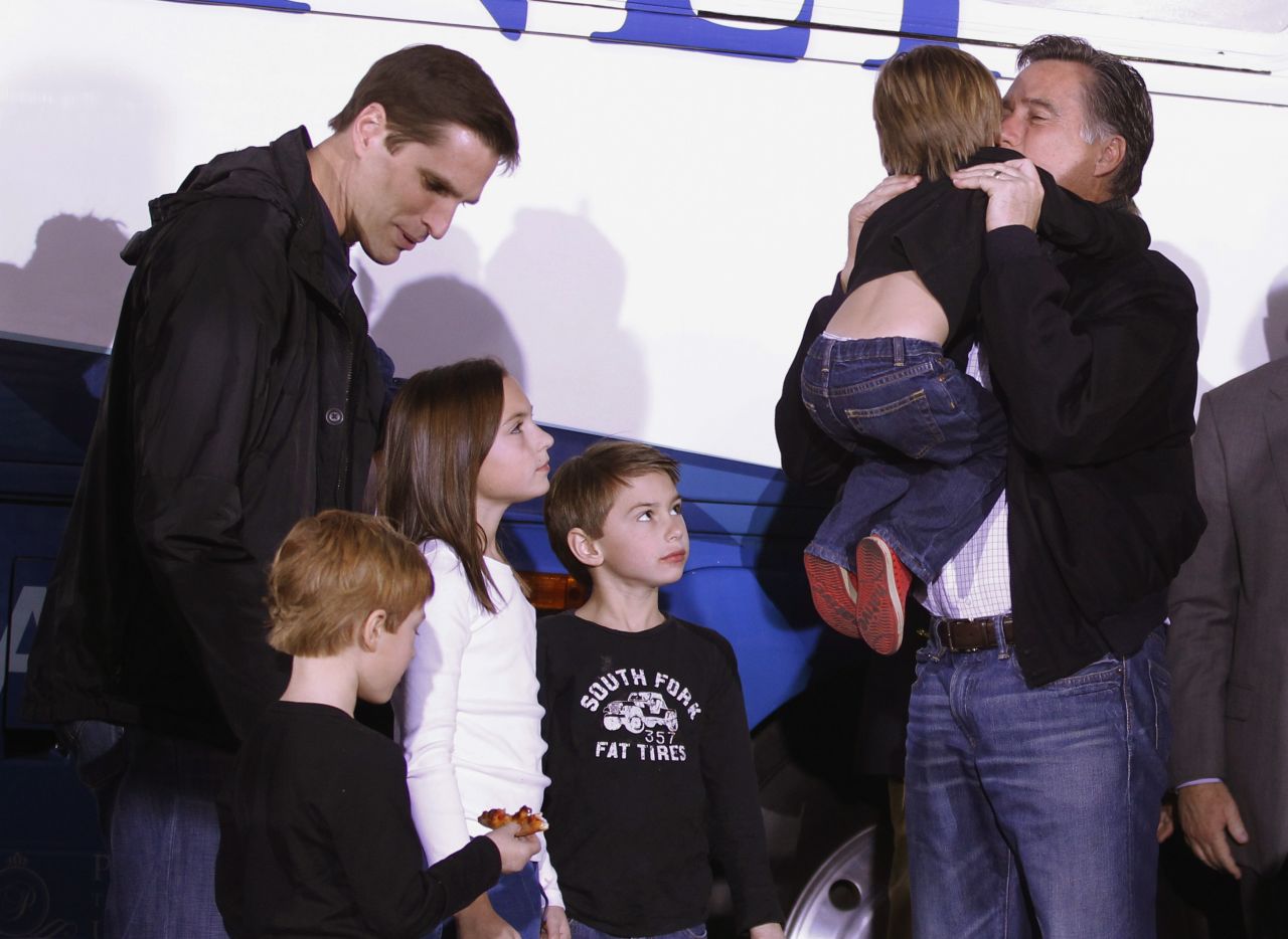 Mitt Romney gets a hug from his grandson Nash as, left to right, son Josh and grandchildren Owen, Grace and Wyatt look on at a campaign rally in 2012.
