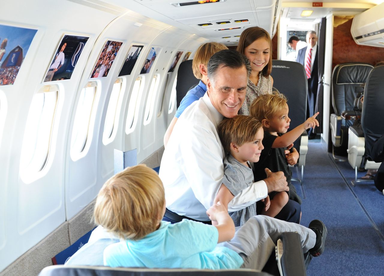 Mitt Romney plays with his son Josh's five children aboard his campaign plane in 2012.