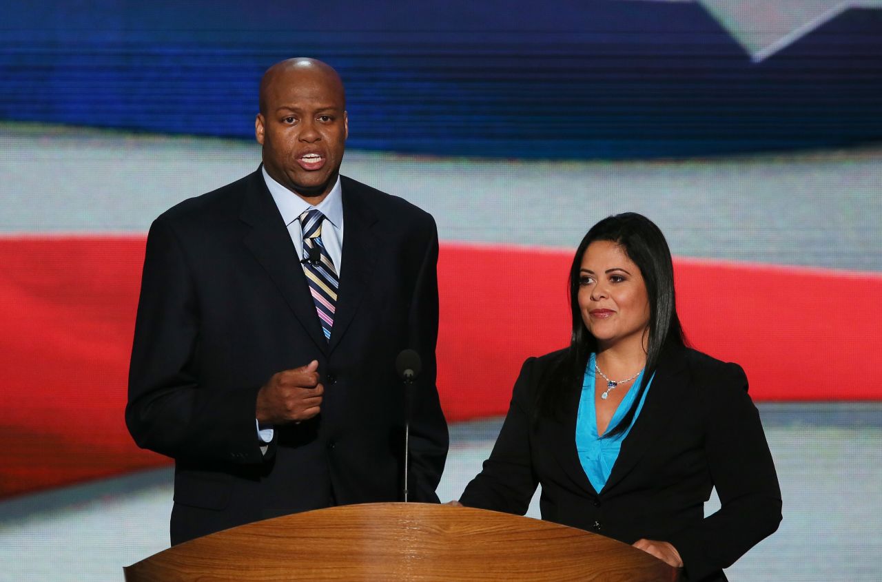 First lady Michelle Obama's brother Craig Robinson and Dr. Maya Kassandra Soetoro-Ng, President Obama's sister, speak on stage during the first day of the 2012 Democratic convention.