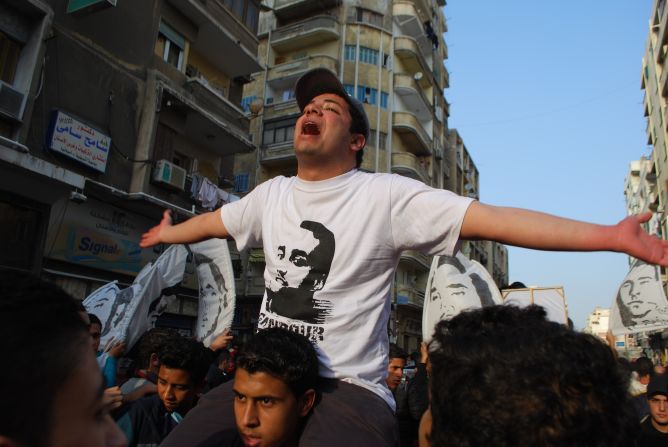 Marches were held across Egypt to honor the dead. Here a member of the Ahlawy leads marchers in song in the northern city of Alexandria. The soccer league was canceled. In their aim to achieve justice for the dead, the Ahlawy has launched a successful direct action campaign against the restart of the soccer league until the trial of those accused of the Port Said tragedy is completed.