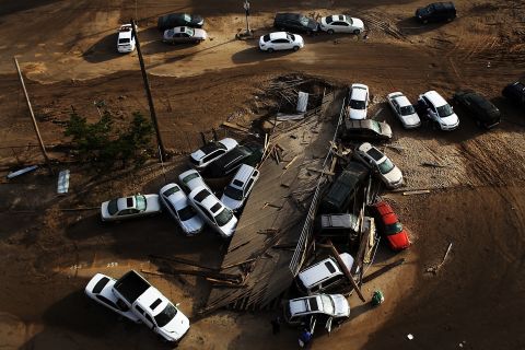 Abandoned and flooded cars are piled up on Friday, November 2, in the heavily damaged Rockaway neighborhood, in Queens, where a large section of a landmark boardwalk was washed away.