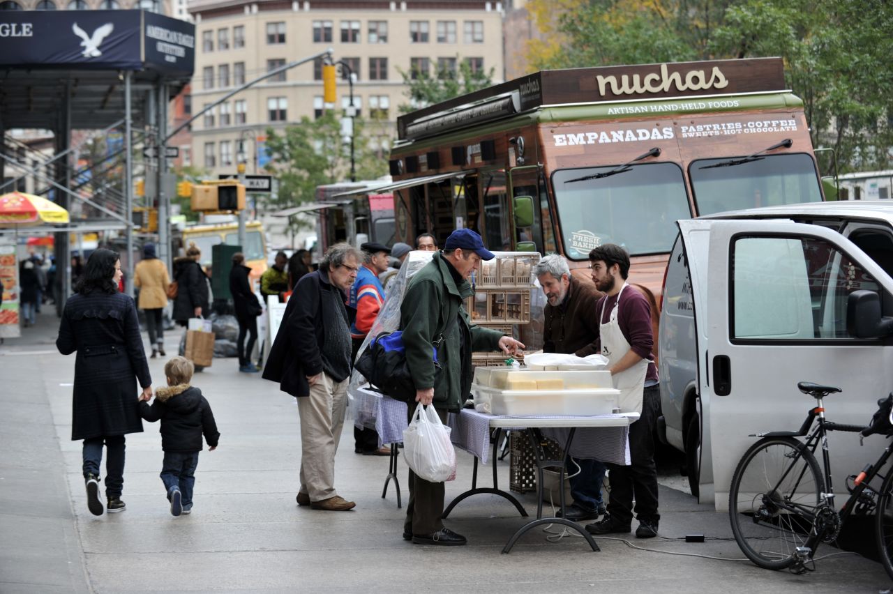 Food trucks and men selling bread and cheeses line Broadway at Union Square on Friday in New York as the city recovers from the effects of Superstorm Sandy.