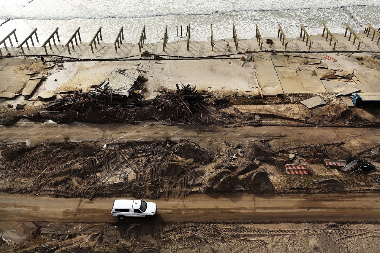 Debris piles up near the foundations of the iconic boardwalk, which was washed away in the Rockaway neighborhood in Queens.