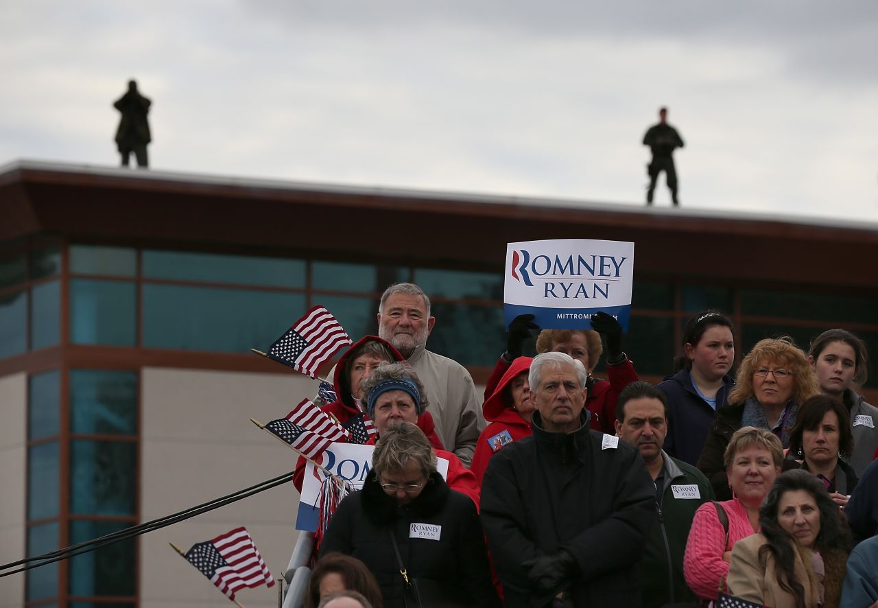 Supporters look on as Romney speaks during a campaign rally in Newington, New Hampshire, on Saturday.