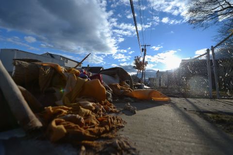 Flood-damaged belongings sit on the side of the road in Union Beach on Friday.