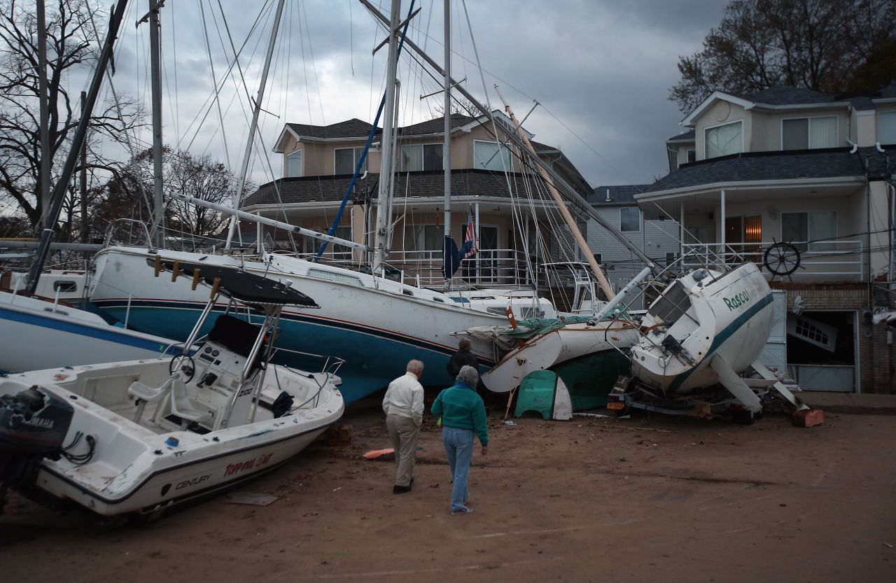 Boats that were swept aground during Sandy sit against homes near a marina on Staten Island on Friday, November 2.