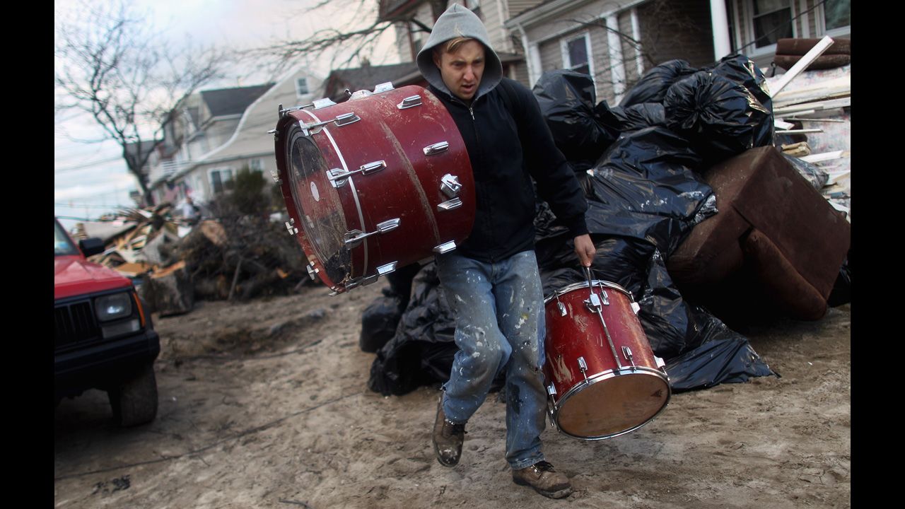  A man salvages a set of drums at Rockaway Beach in Queens, New York, on Saturday. Most of the Rockaway Peninsula remains without power.