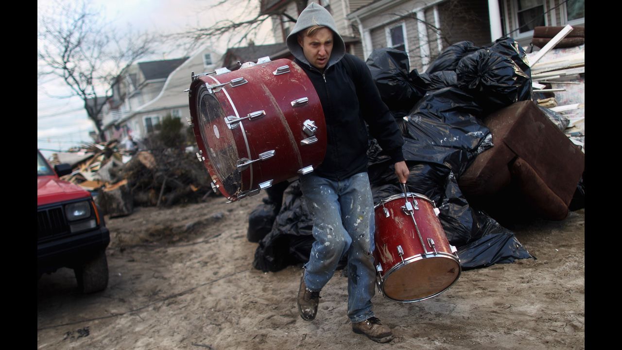 A man salvages a set of drums at Rockaway Beach in Queens, New York, on Saturday. Most of the Rockaway Peninsula remains without power.